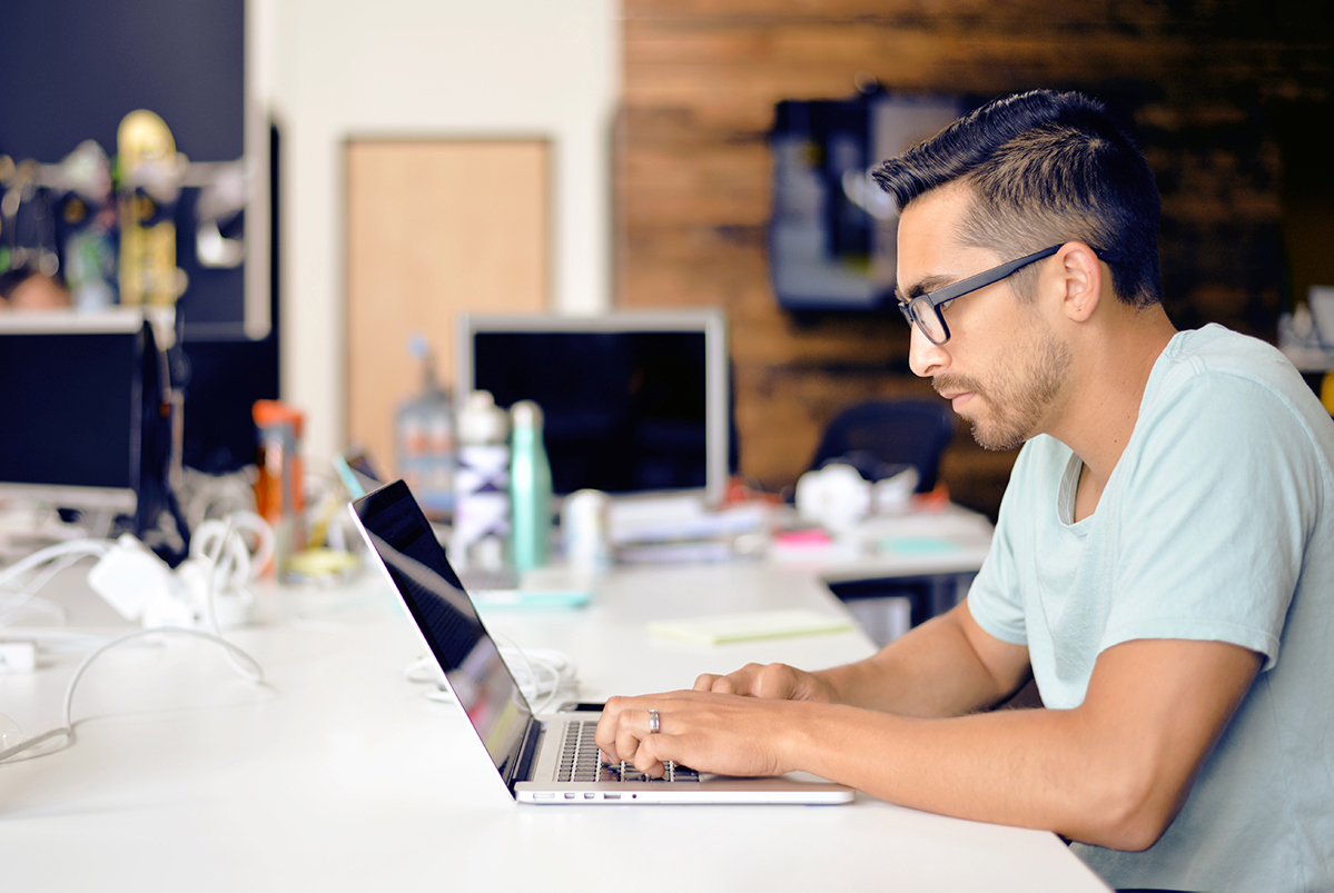 Man completing e-learning module on laptop.